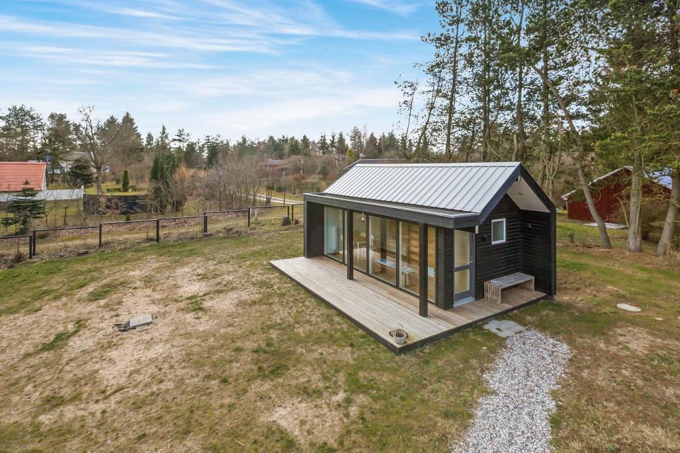 This Scandinavian Modern tiny house in Denmark has a 258 sq ft studio floor plan with sleeping loft. | www.facebook.com/SmallHouseBliss
