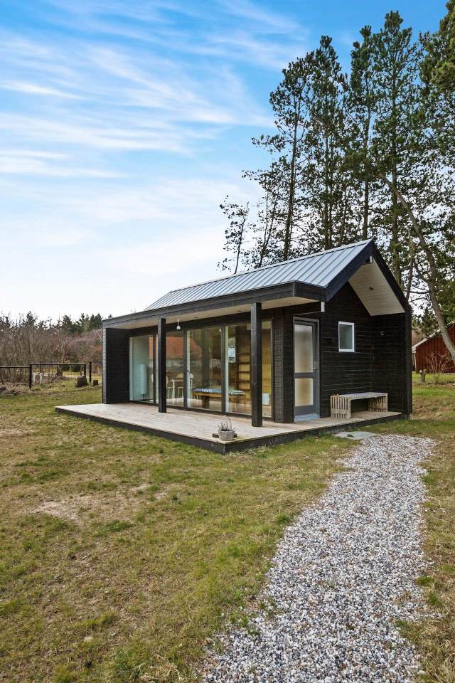 This Scandinavian Modern tiny house in Denmark has a 258 sq ft studio floor plan with sleeping loft. | www.facebook.com/SmallHouseBliss