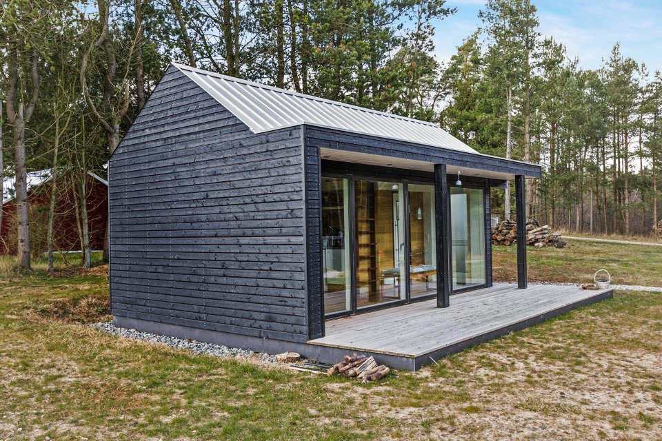 This Scandinavian Modern tiny house in Denmark has a 258 sq ft studio floor plan with sleeping loft. | www.facebook.com/SmallHouseBliss