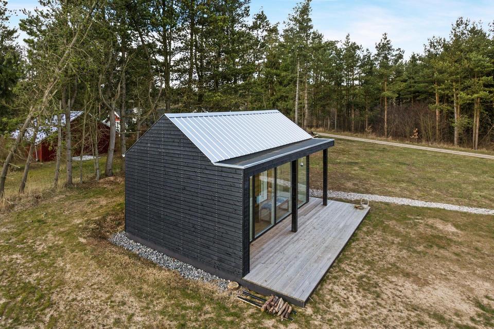 This Scandinavian Modern tiny house in Denmark has a 258 sq ft studio floor plan with sleeping loft. | www.facebook.com/SmallHouseBliss
