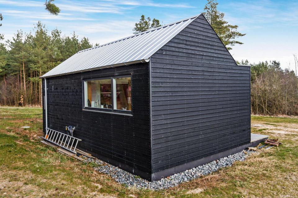 This Scandinavian Modern tiny house in Denmark has a 258 sq ft studio floor plan with sleeping loft. | www.facebook.com/SmallHouseBliss