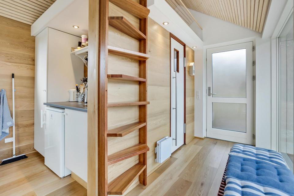 This Scandinavian Modern tiny house in Denmark has a 258 sq ft studio floor plan with sleeping loft. | www.facebook.com/SmallHouseBliss