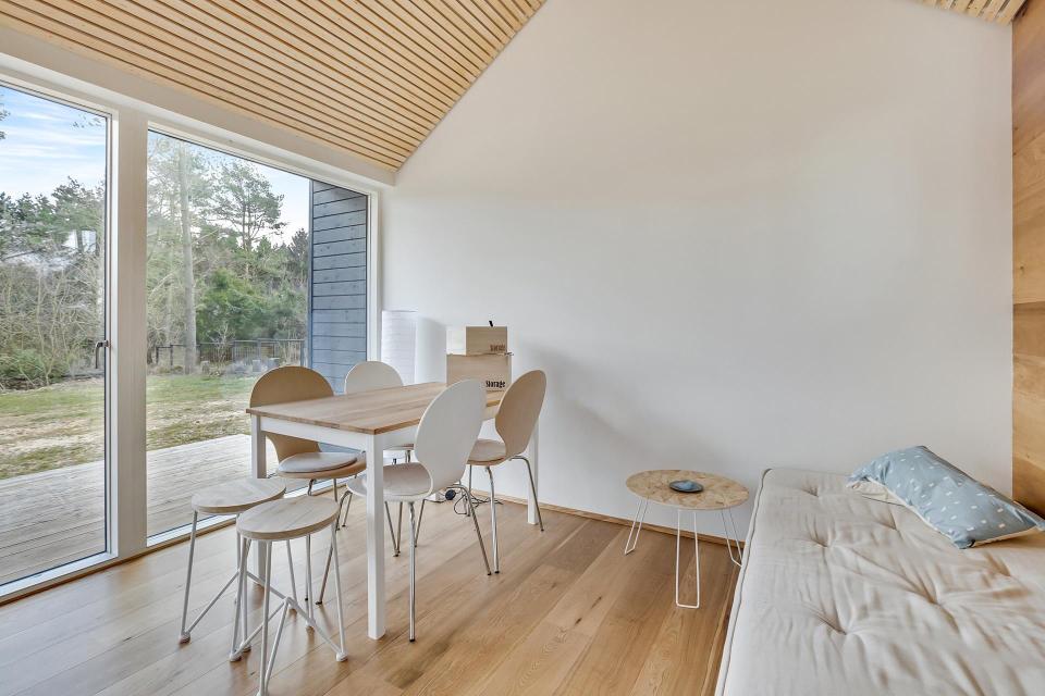 This Scandinavian Modern tiny house in Denmark has a 258 sq ft studio floor plan with sleeping loft. | www.facebook.com/SmallHouseBliss