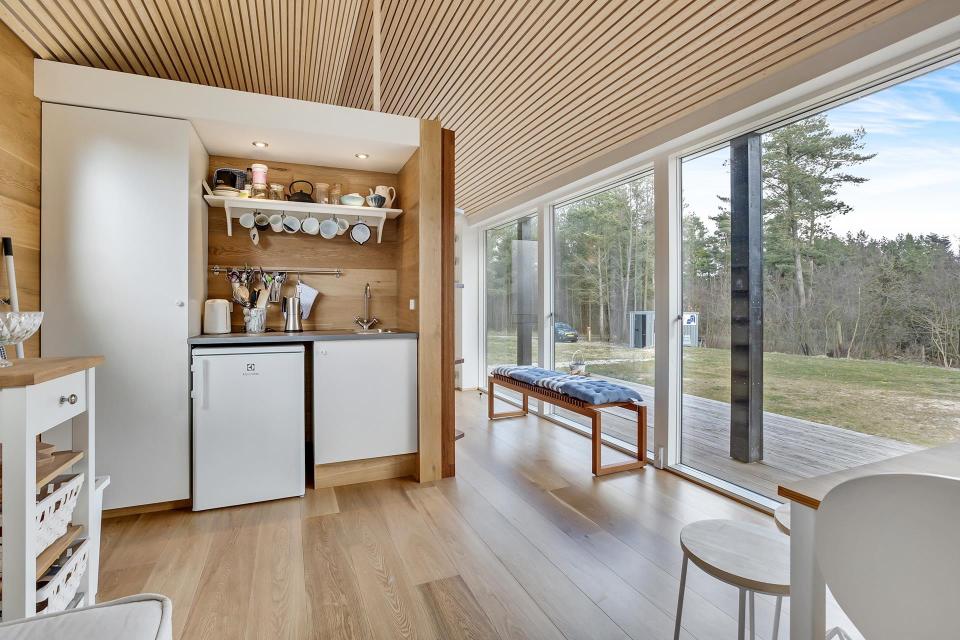 This Scandinavian Modern tiny house in Denmark has a 258 sq ft studio floor plan with sleeping loft. | www.facebook.com/SmallHouseBliss