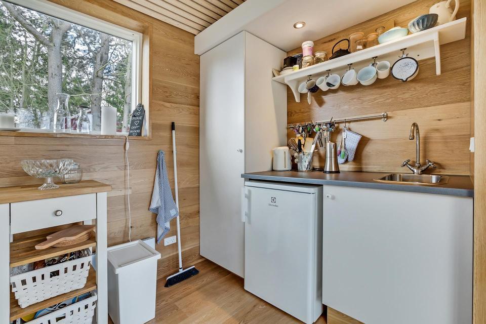 This Scandinavian Modern tiny house in Denmark has a 258 sq ft studio floor plan with sleeping loft. | www.facebook.com/SmallHouseBliss