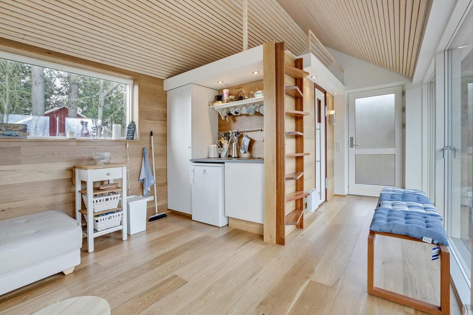 This Scandinavian Modern tiny house in Denmark has a 258 sq ft studio floor plan with sleeping loft. | www.facebook.com/SmallHouseBliss