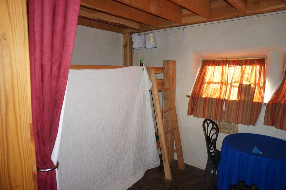 This small straw bale house is off the grid on 40 acres of Colorado pasture, forest and canyon. It has one bedroom on the 468 sq ft ground floor plus a loft. | www.facebook.com/SmallHouseBliss