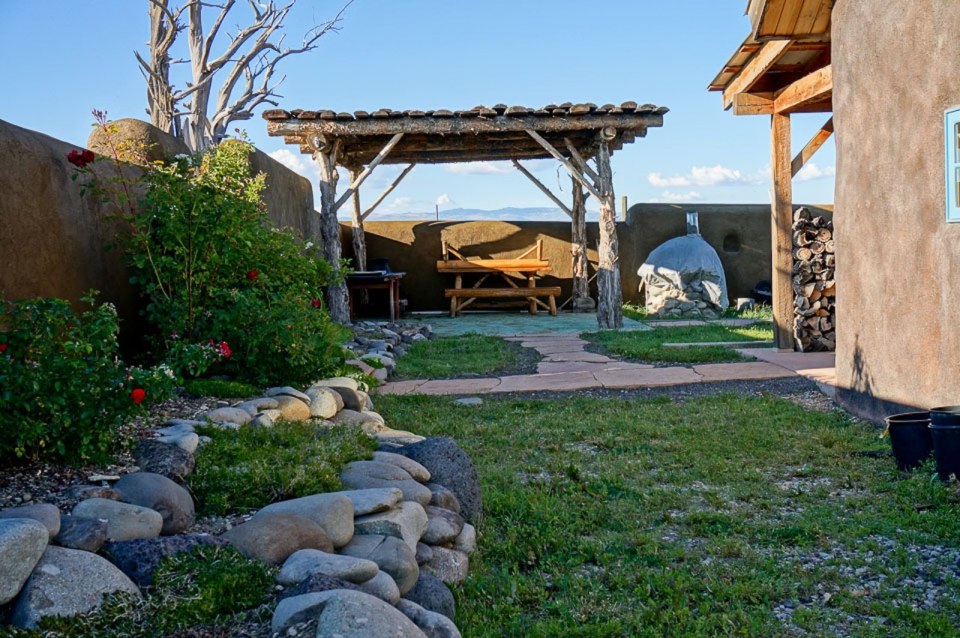 This small straw bale house is off the grid on 40 acres of Colorado pasture, forest and canyon. It has one bedroom on the 468 sq ft ground floor plus a loft. | www.facebook.com/SmallHouseBliss