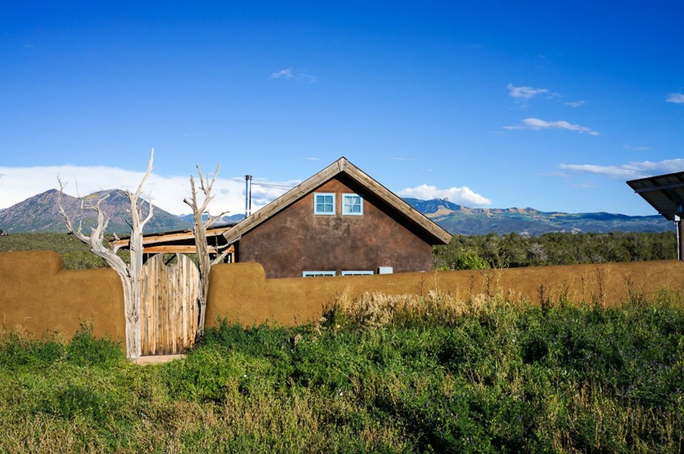 This small straw bale house is off the grid on 40 acres of Colorado pasture, forest and canyon. It has one bedroom on the 468 sq ft ground floor plus a loft. | www.facebook.com/SmallHouseBliss