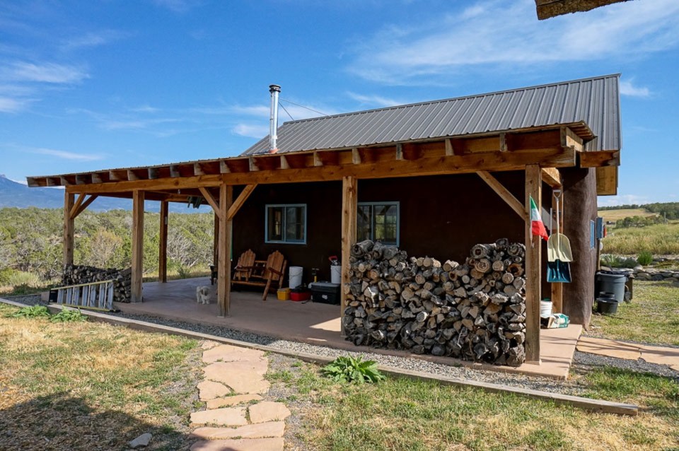 This small straw bale house is off the grid on 40 acres of Colorado pasture, forest and canyon. It has one bedroom on the 468 sq ft ground floor plus a loft. | www.facebook.com/SmallHouseBliss