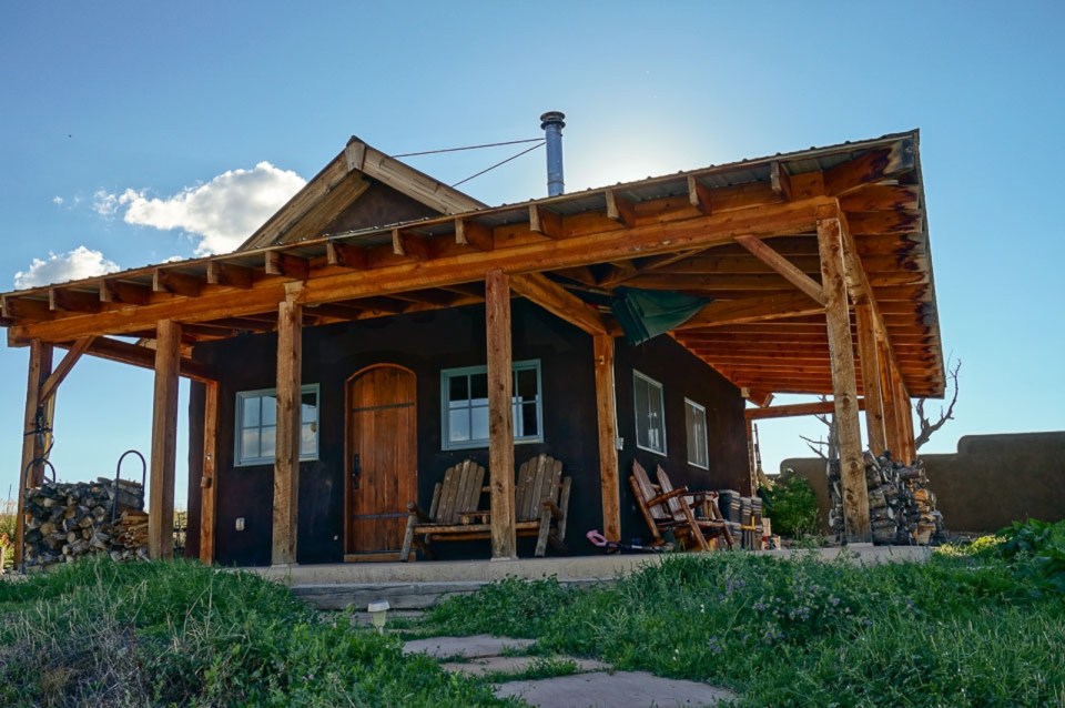 This small straw bale house is off the grid on 40 acres of Colorado pasture, forest and canyon. It has one bedroom on the 468 sq ft ground floor plus a loft. | www.facebook.com/SmallHouseBliss