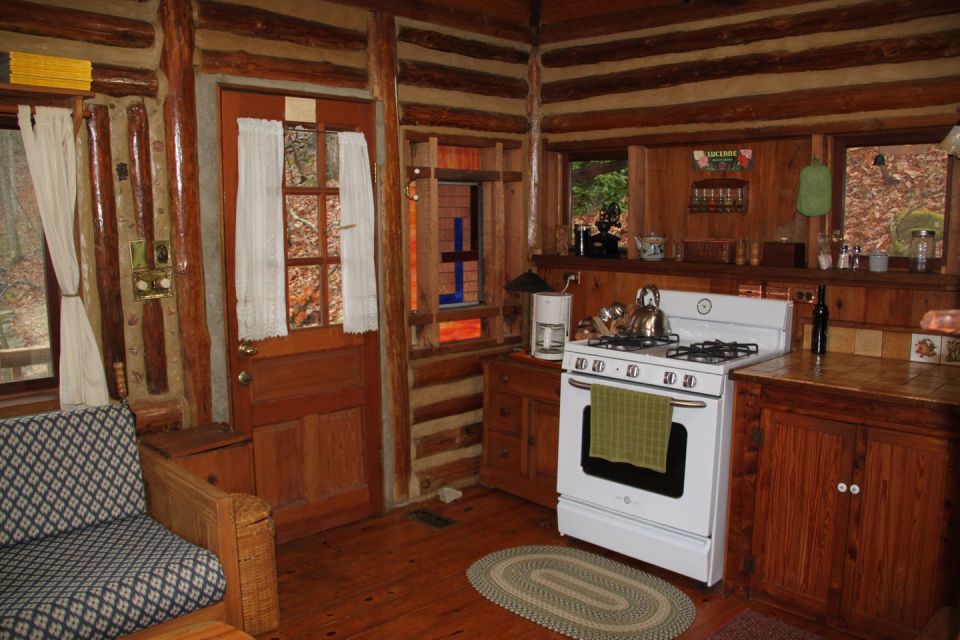 The Perch, a 1920s log cabin resembling a forest fire lookout tower. It has one bedroom in roughly 600 sq ft. | www.facebook.com/SmallHouseBliss