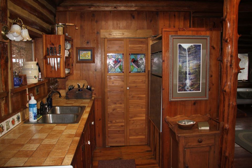The Perch, a 1920s log cabin resembling a forest fire lookout tower. It has one bedroom in roughly 600 sq ft. | www.facebook.com/SmallHouseBliss