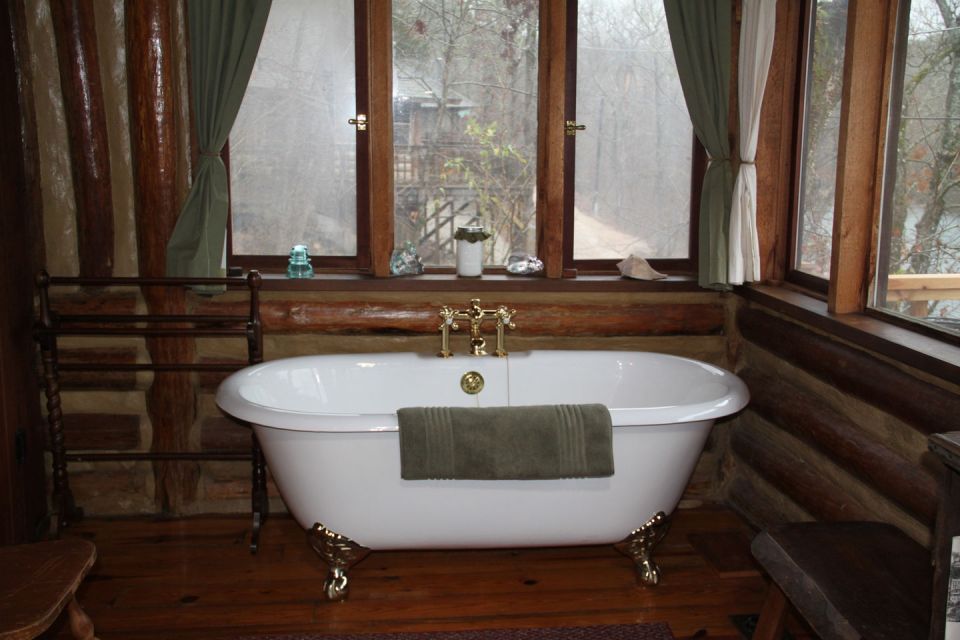 The Perch, a 1920s log cabin resembling a forest fire lookout tower. It has one bedroom in roughly 600 sq ft. | www.facebook.com/SmallHouseBliss