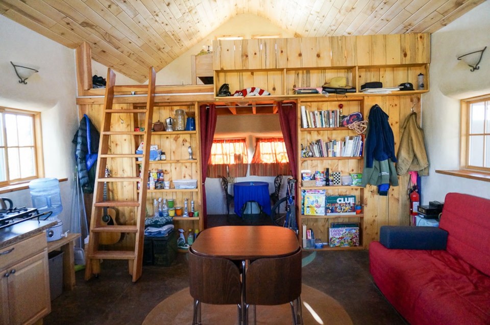 This tiny straw bale house is off the grid on 40 acres of Colorado pasture, forest and canyon. It has one bedroom on the 468 sq ft ground floor plus a loft. | www.facebook.com/SmallHouseBliss