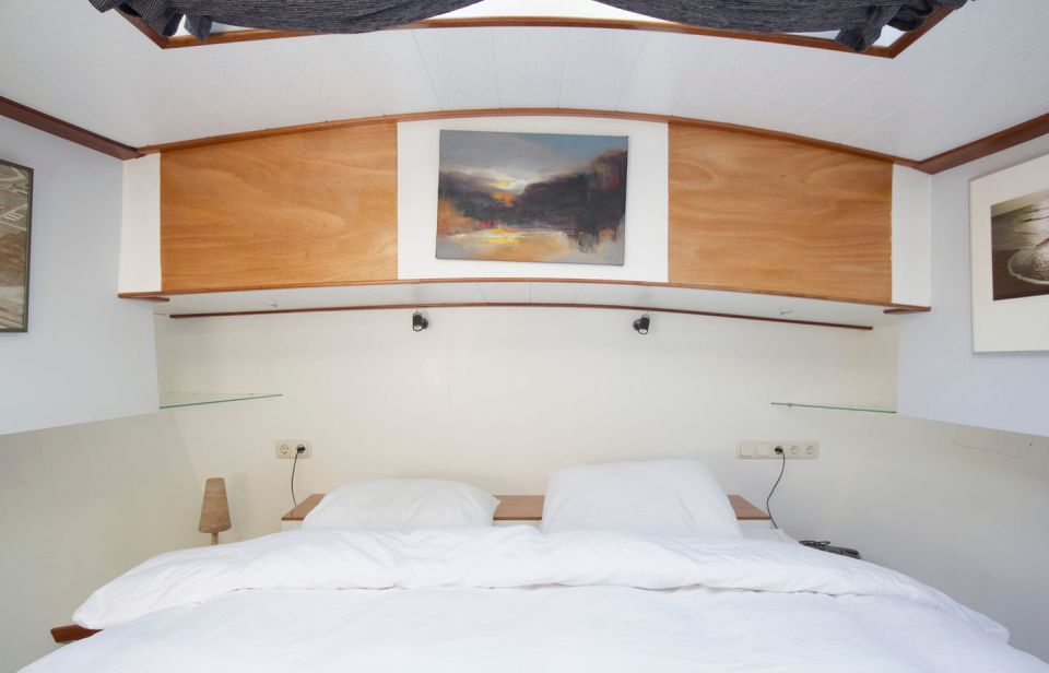 A canal barge built in 1908 was converted into this comfortable two-bedroom houseboat in Amsterdam. | www.facebook.com/SmallHouseBliss