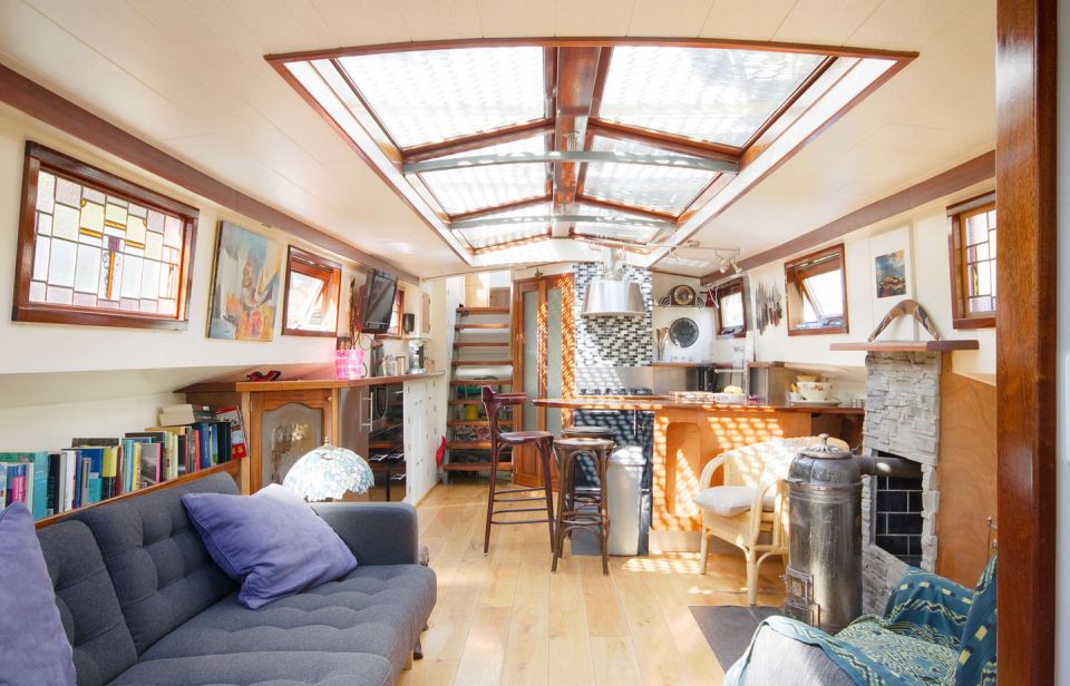 A canal barge built in 1908 was converted into this comfortable two-bedroom houseboat in Amsterdam. | www.facebook.com/SmallHouseBliss