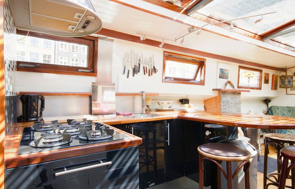 A canal barge built in 1908 was converted into this comfortable two-bedroom houseboat in Amsterdam. | www.facebook.com/SmallHouseBliss