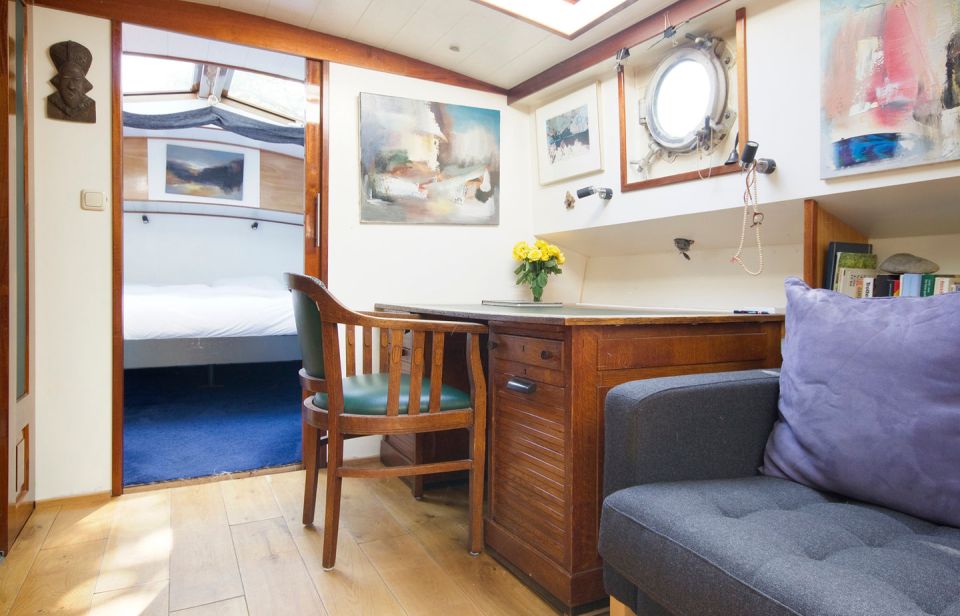 A canal barge built in 1908 was converted into this comfortable two-bedroom houseboat in Amsterdam. | www.facebook.com/SmallHouseBliss