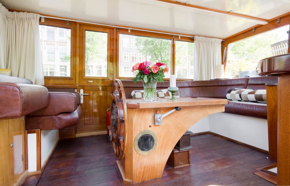 A canal barge built in 1908 was converted into this comfortable two-bedroom houseboat in Amsterdam. | www.facebook.com/SmallHouseBliss