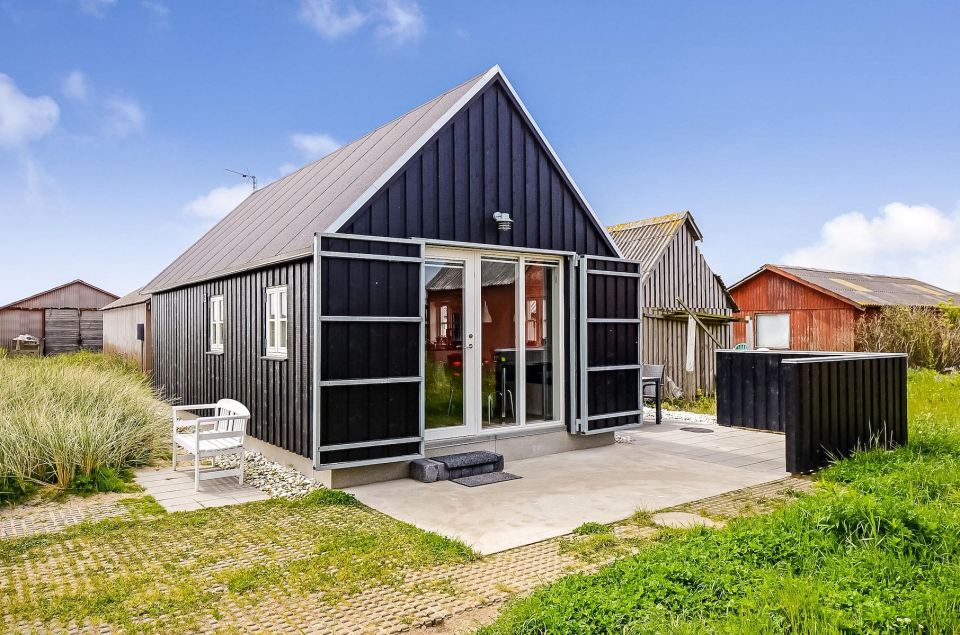 This Danish summerhouse was inspired by the neighboring fishermen's sheds. It has one bedroom on the 375 sq ft ground floor, plus a sleeping loft. | www.facebook.com/SmallHouseBliss
