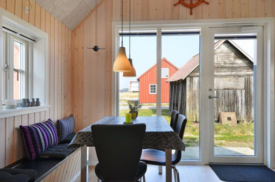 This Danish summerhouse was inspired by the neighboring fishermen's sheds. It has one bedroom on the 375 sq ft ground floor, plus a sleeping loft. | www.facebook.com/SmallHouseBliss