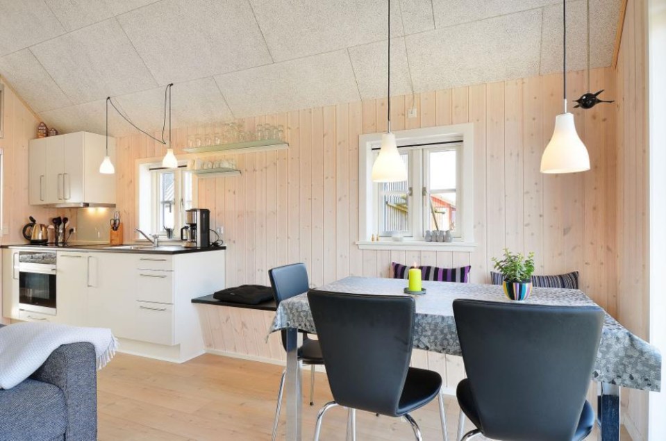 This Danish summerhouse was inspired by the neighboring fishermen's sheds. It has one bedroom on the 375 sq ft ground floor, plus a sleeping loft. | www.facebook.com/SmallHouseBliss
