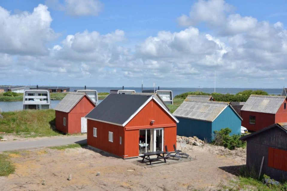 This Danish summerhouse was inspired by the neighboring fishermen's sheds. It has one bedroom on the 375 sq ft ground floor, plus a sleeping loft. | www.facebook.com/SmallHouseBliss