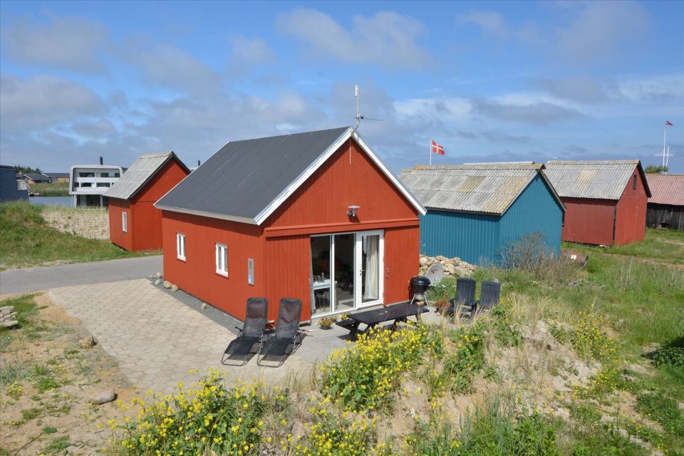 This Danish summerhouse was inspired by the neighboring fishermen's sheds. It has one bedroom on the 375 sq ft ground floor, plus a sleeping loft. | www.facebook.com/SmallHouseBliss