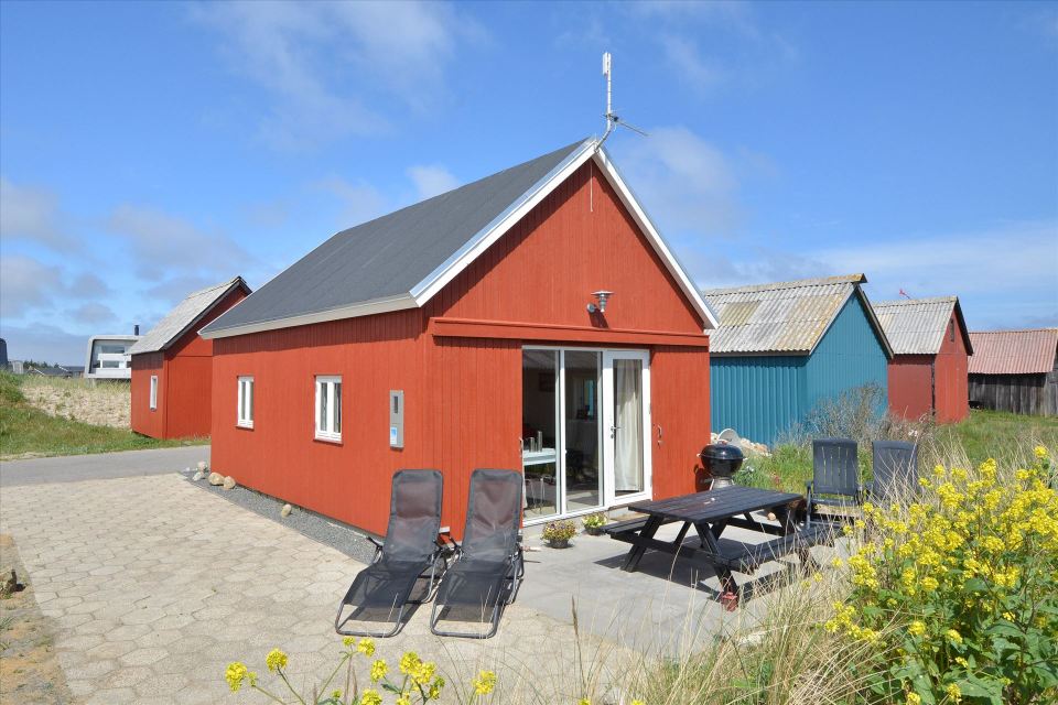 This Danish summerhouse was inspired by the neighboring fishermen's sheds. It has one bedroom on the 375 sq ft ground floor, plus a sleeping loft. | www.facebook.com/SmallHouseBliss