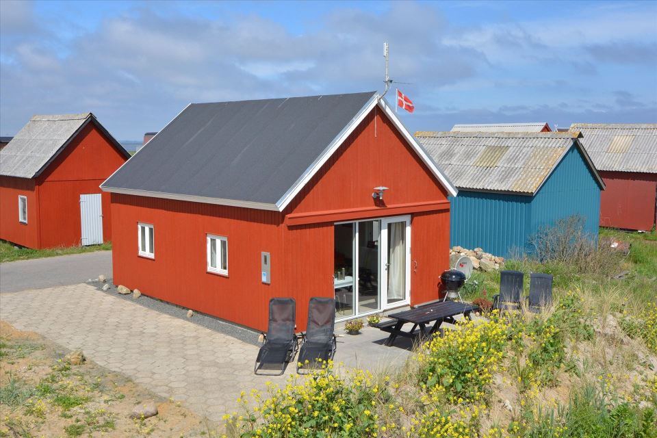 This Danish summerhouse was inspired by the neighboring fishermen's sheds. It has one bedroom on the 375 sq ft ground floor, plus a sleeping loft. | www.facebook.com/SmallHouseBliss