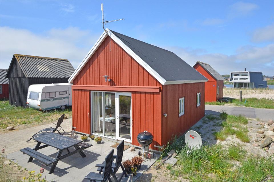 This Danish summerhouse was inspired by the neighboring fishermen's sheds. It has one bedroom on the 375 sq ft ground floor, plus a sleeping loft. | www.facebook.com/SmallHouseBliss