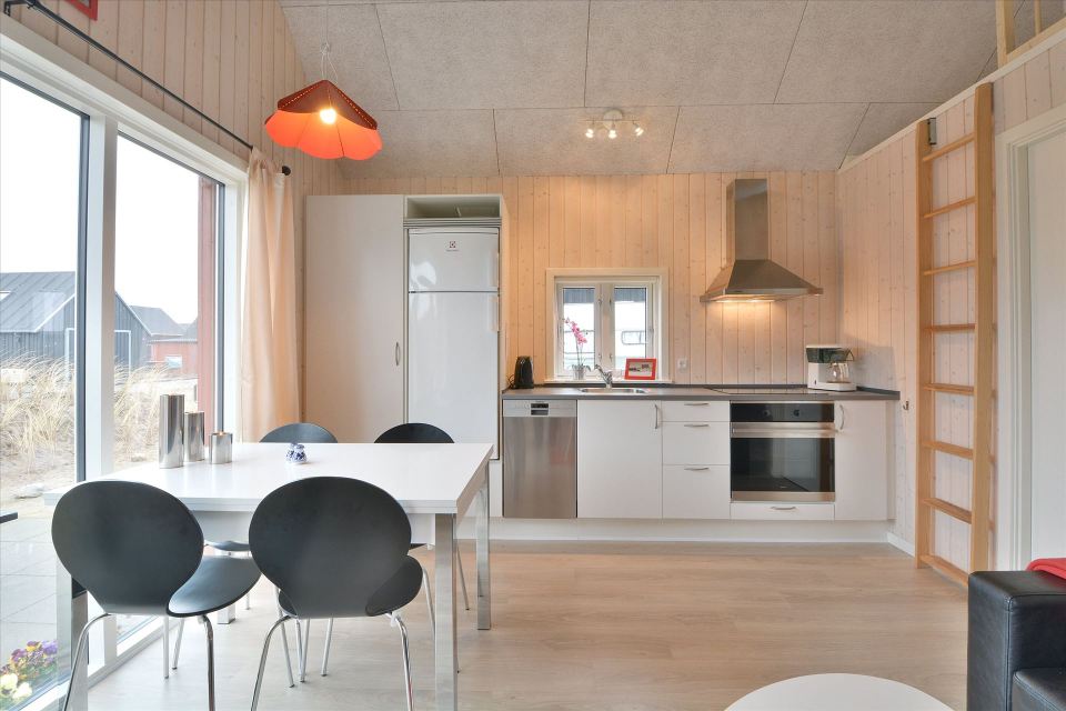 This Danish summerhouse was inspired by the neighboring fishermen's sheds. It has one bedroom on the 375 sq ft ground floor, plus a sleeping loft. | www.facebook.com/SmallHouseBliss