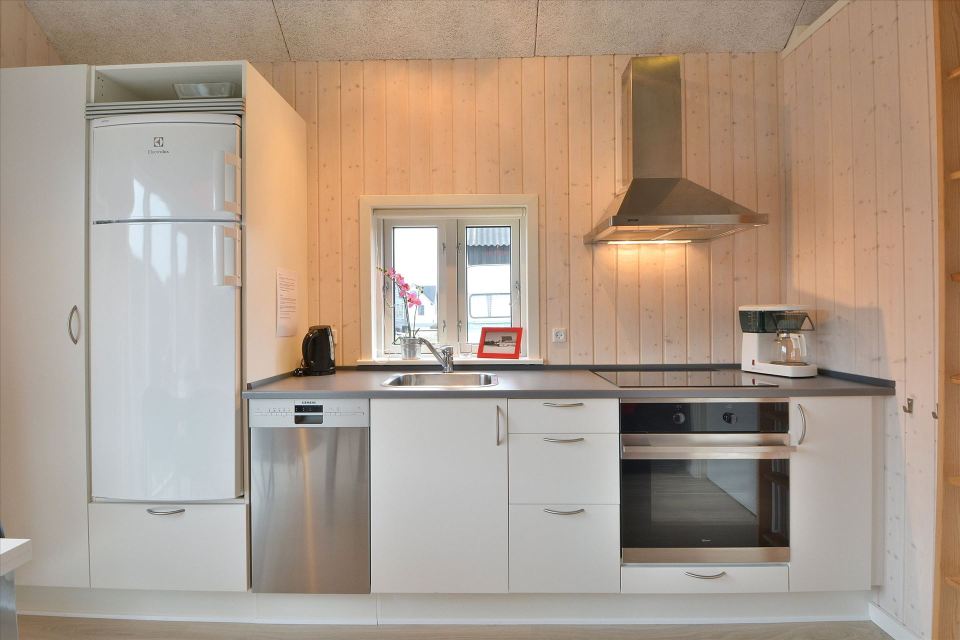 This Danish summerhouse was inspired by the neighboring fishermen's sheds. It has one bedroom on the 375 sq ft ground floor, plus a sleeping loft. | www.facebook.com/SmallHouseBliss