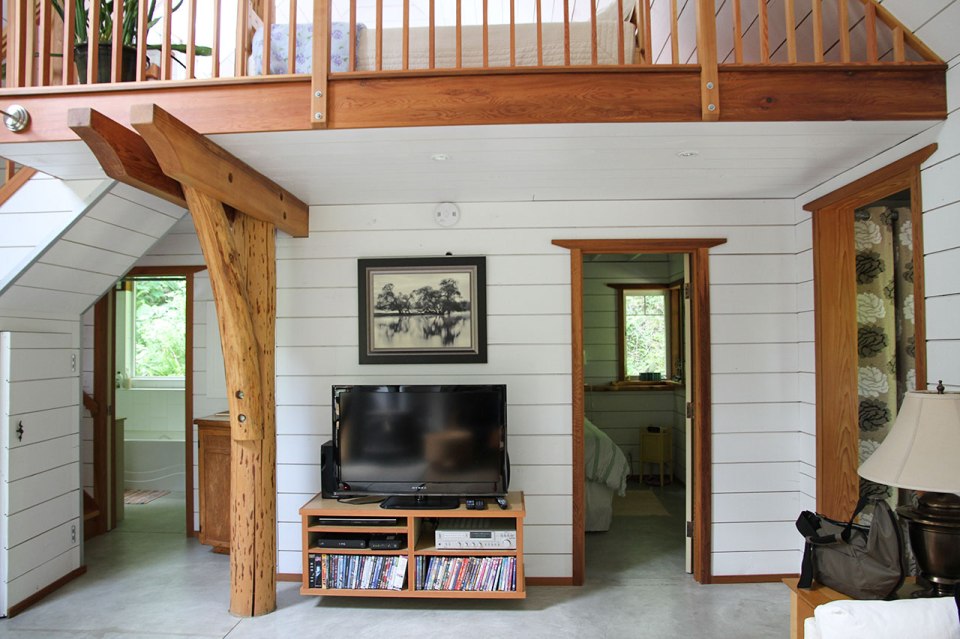 Birds' Hill Cottage is nestled in the rainforest on BC's Salt Spring Island. It has a ground-floor bedroom plus a large bedroom loft in roughly 800 sq ft. | www.facebook.com/SmallHouseBliss