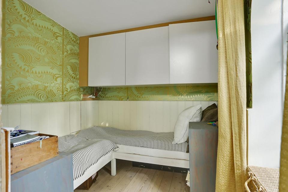 This fanciful allotment hut in Denmark has a tiny bedroom, a sleeping alcove and a sleeping loft in its 645 sq ft. | www.facebook.com/SmallHouseBliss