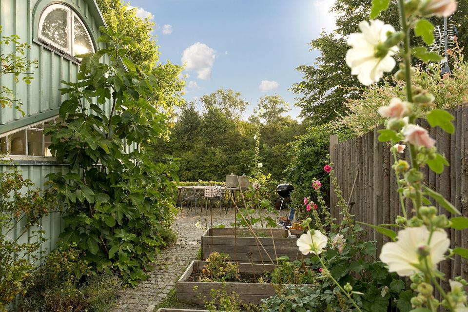 This fanciful allotment hut in Denmark has a tiny bedroom, a sleeping alcove and a sleeping loft in its 645 sq ft. | www.facebook.com/SmallHouseBliss