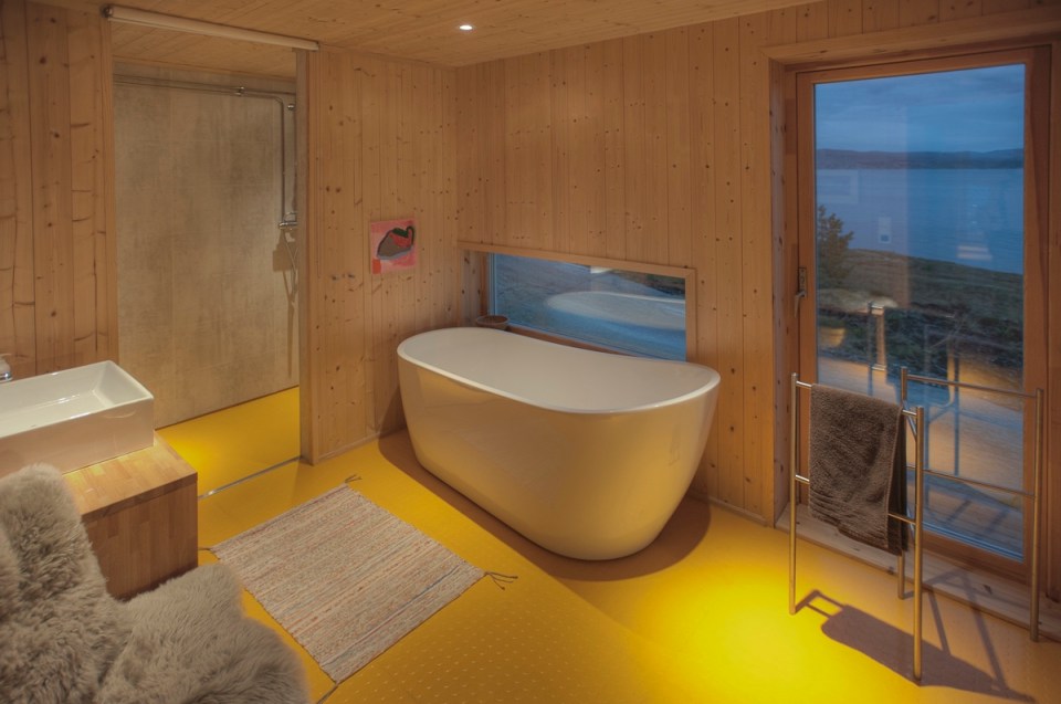 This modern wood cabin sits on the rugged coast of Norway. It has a bedroom, a sleeping nook and a loft, all in a footprint of just 645 sq ft. | www.facebook.com/SmallHouseBliss