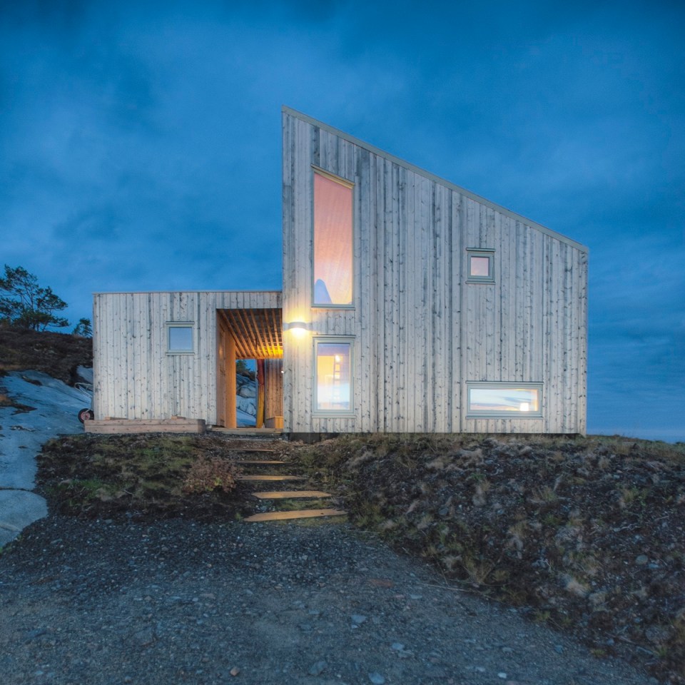 This modern wood cabin sits on the rugged coast of Norway. It has a bedroom, a sleeping nook and a loft, all in a footprint of just 645 sq ft. | www.facebook.com/SmallHouseBliss