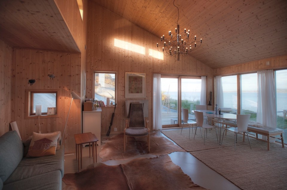 This modern wood cabin sits on the rugged coast of Norway. It has a bedroom, a sleeping nook and a loft, all in a footprint of just 645 sq ft. | www.facebook.com/SmallHouseBliss