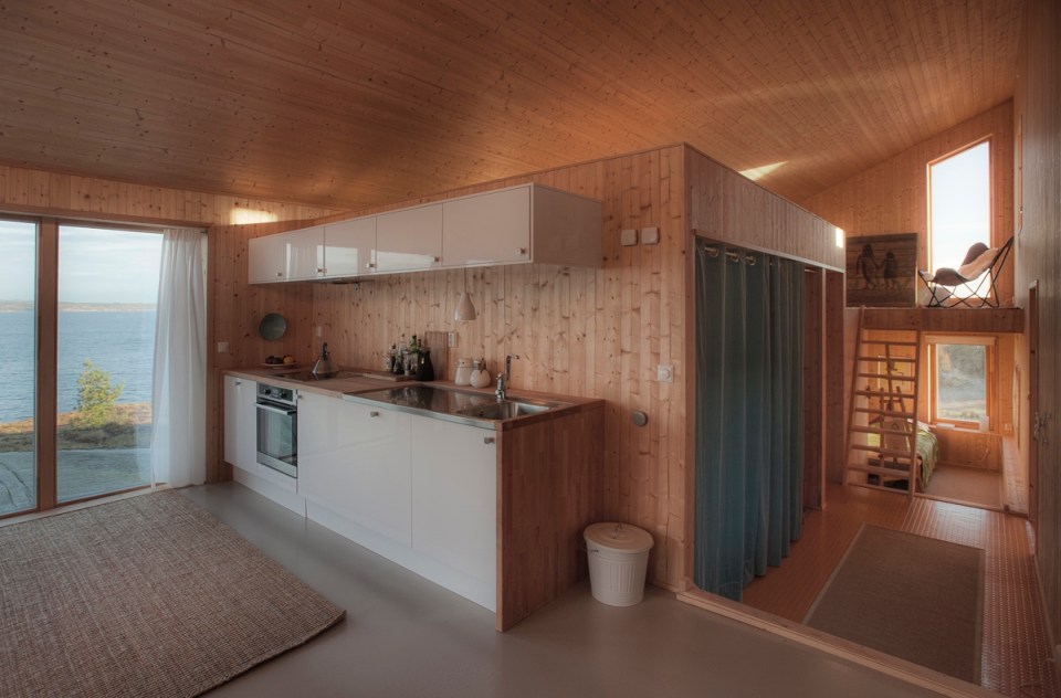 This modern wood cabin sits on the rugged coast of Norway. It has a bedroom, a sleeping nook and a loft, all in a footprint of just 645 sq ft. | www.facebook.com/SmallHouseBliss